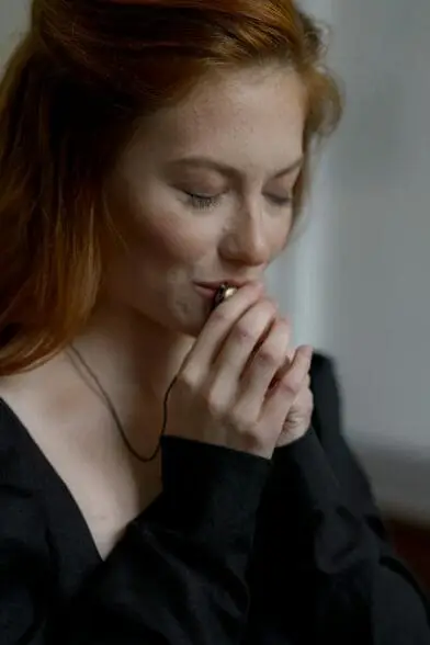 Woman Kissing Her Necklace