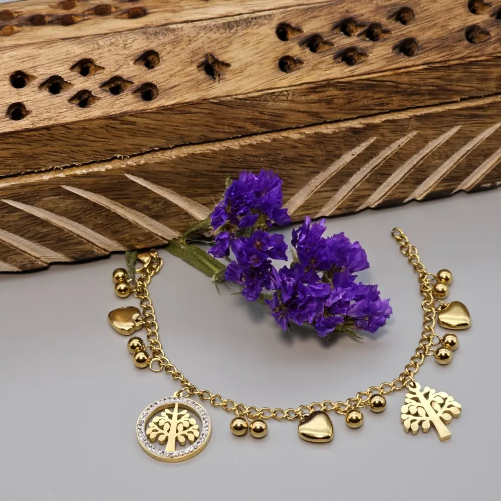 "Heart and Tree Charms Necklace displayed on a light gray background with a violet flower in the center."