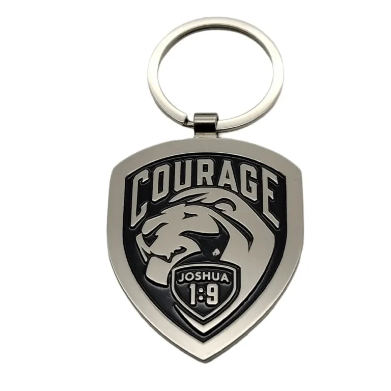 Silver keychain with "COURAGE JOSHUA 1:9" lion design